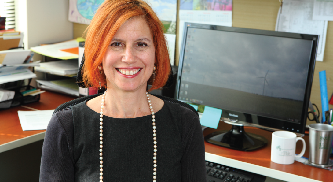 Headshot of Cynthia Klein Banai. She is smiling in front of her desk.