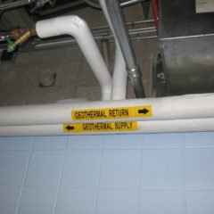 pipes inside Grant Hall of the geothermal heat exchange. one says 