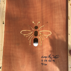 bee artwork carved on wood