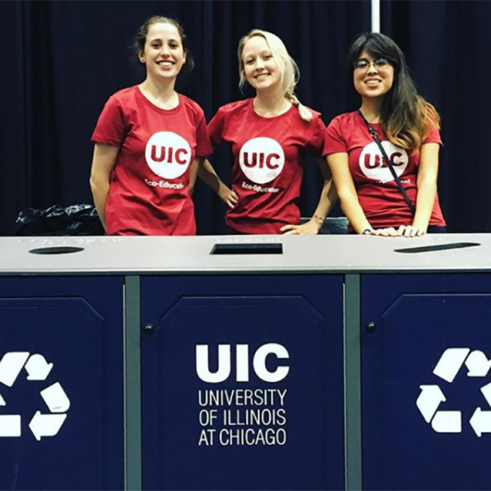 Eco-Educators behind a recycling station at the UIC Forum