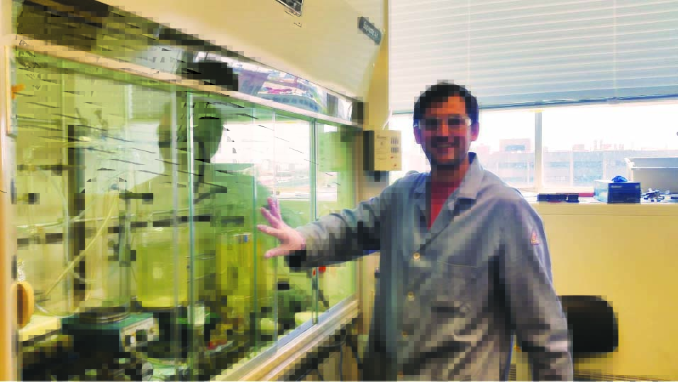 researcher closes the fume hood in his lab