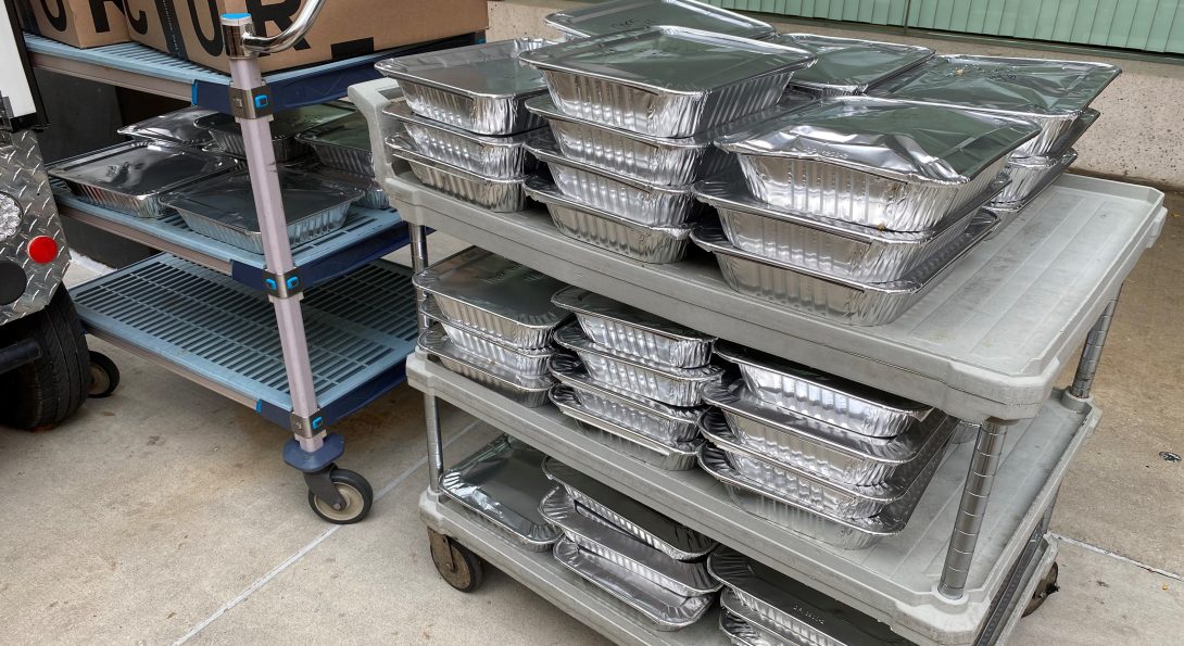 Food from the UI Hospital has been packaged in aluminum containers and is ready to be transported to Fransiscan House, a nearby homeless shelter.